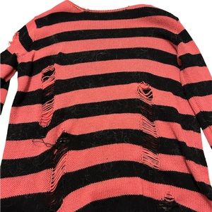 pink and black distressed sweater